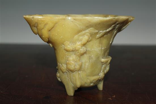 A Chinese pale green soapstone libation cup, 19th century, width 18.5cm, height 10cm, faults